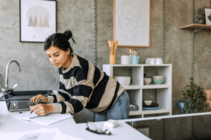 Young beautiful woman working from her apartment.